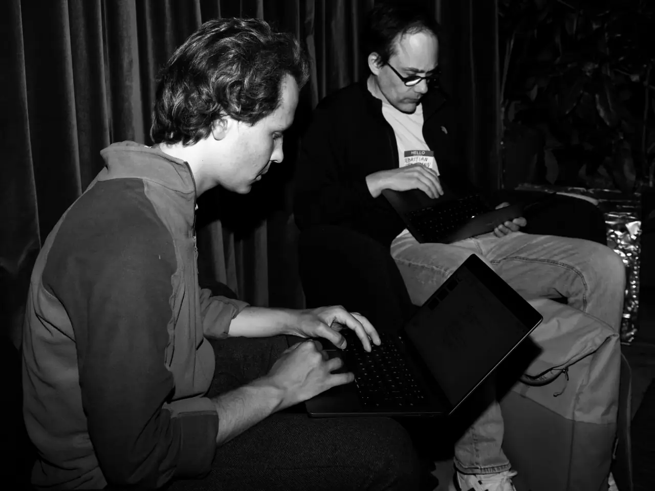 Two attendees on a laptop