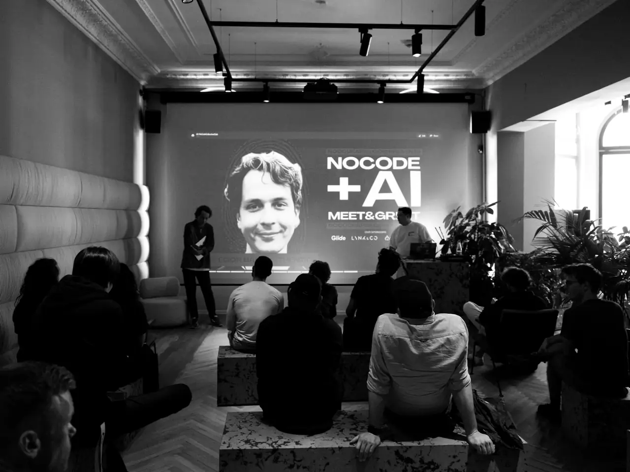 Audience, event poster on screen